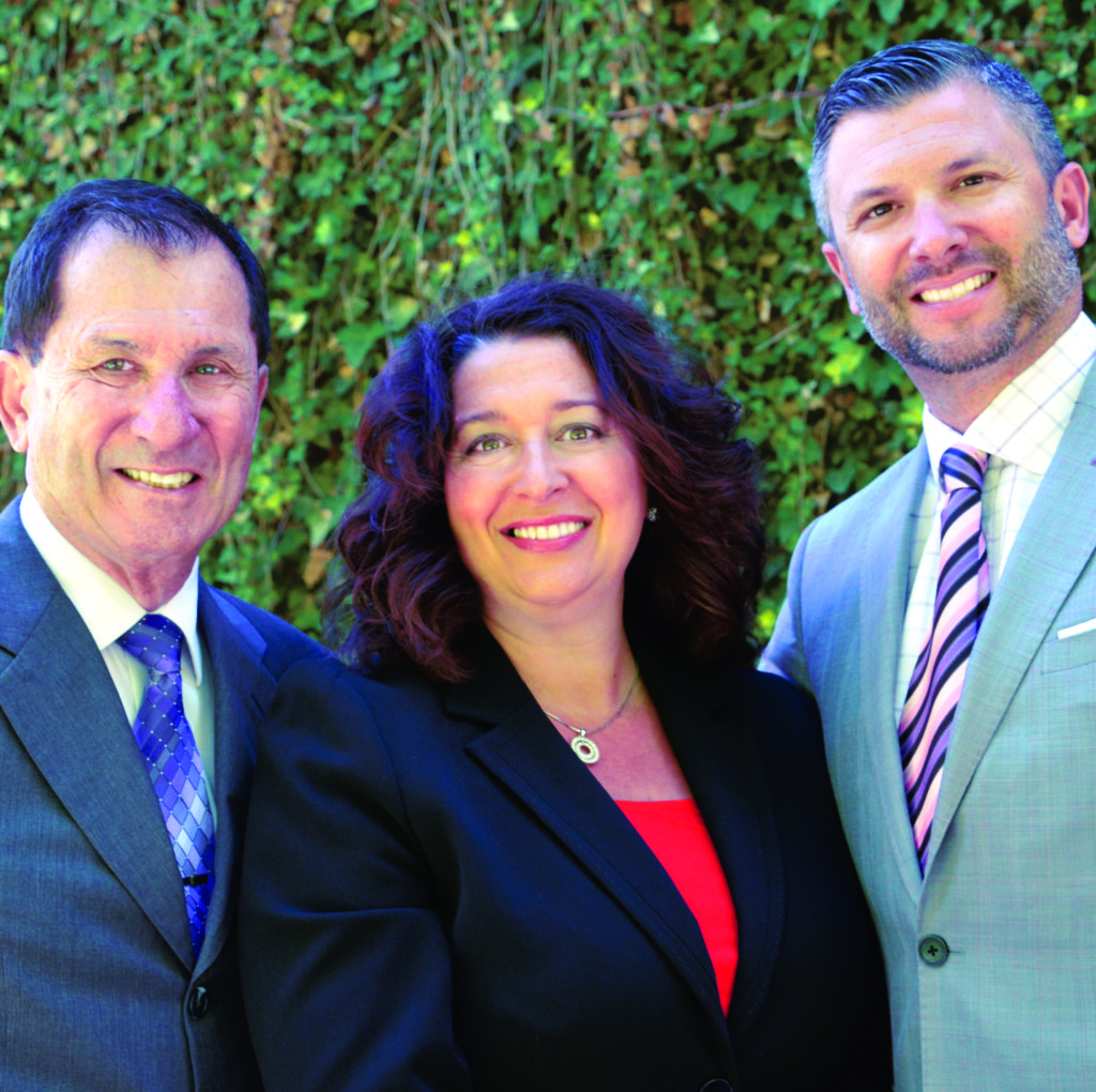 Larry Freiburger, Janet McKenzie, and Scott Freiburger smiling for camera.