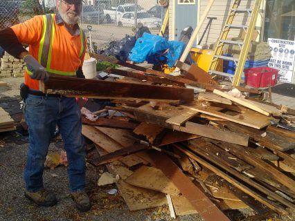 AET employee disposing of renovation waste outside the head office in Kitchener.