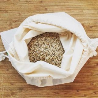 Rice in a bag sitting on a cutting board. 