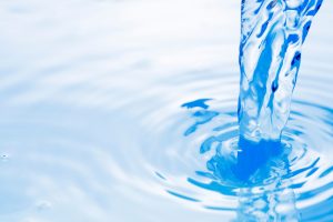 iStock-1381613867-resized Clear blue water pouring into a pool